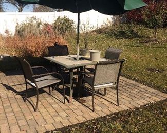 patio set includes table, chairs and umbrella