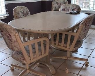 Kitchen table with six captains chairs on wheels