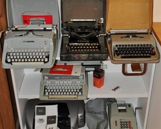 Vintage typewriters including two Hermes typewriters and one Hermes calculator