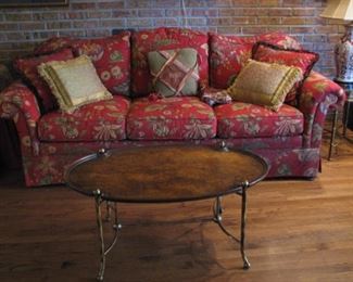Plush red sofa and brass coffee table