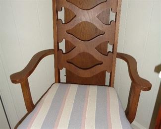 closeup of dining room chairs, leaf is behind chair