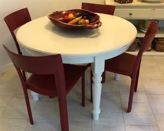 Wonderful white table (pottery barn I think)  - has 2 leaves - talavera , red chairs by Maria Ye