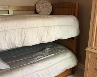 Twin bunk beds with a bottom trundle