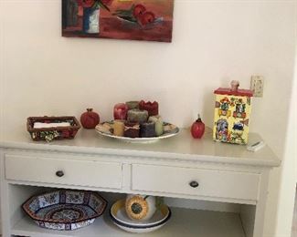 Wooden cabinet filled with fun pottery and baskets