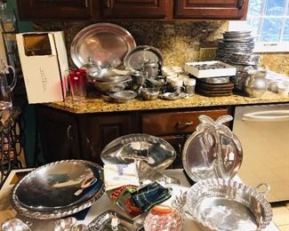 Large collection of cast aluminum serving pieces and dinner plates