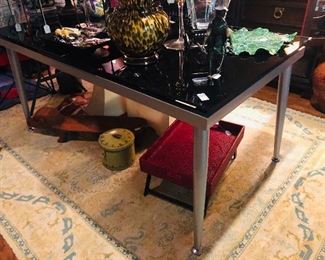 Wonderful black glass and stainless dining table with one pop up glass leaf. 