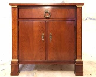 Biedermeier or federal style cabinet with book-matched veneer and gilded details.