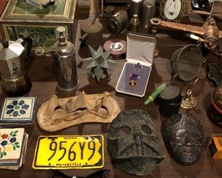Purple Heart medal, native american indian birch bark teepee model, motorcycle license plate, vintage wall pencil sharpener, tin ware, WWII airplane model.