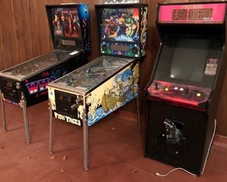 2 pinball machines and a pacman video game.