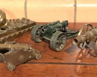 grouping of brass cannon models.
