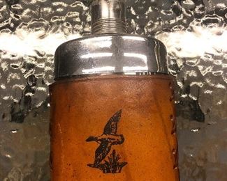 Flask in a leather pouch with bird