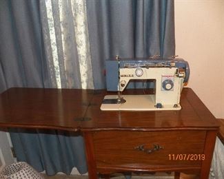 White cabinet sewing machine