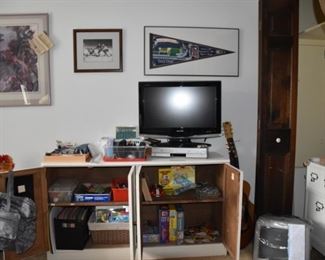 TV, Framed Art, Tiger Pendant, Hockey, Apple Computer, File Cabinet