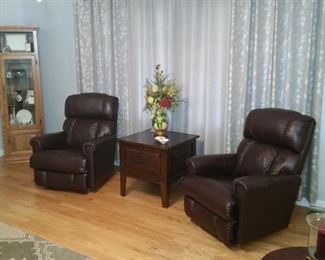 These two leather leather rocker recliners match the sofa.