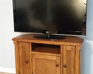 LG LCD 47 inch TV .  Oak cabinet has angled back corners so it can also be used as a corner cabinet