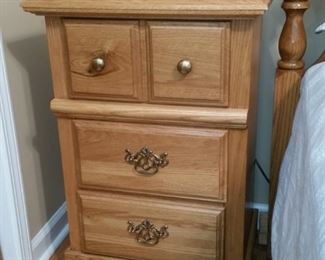 One of two oak nightstands