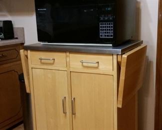 Microwave cart/cabinet is made of maple and has a stainless steel top