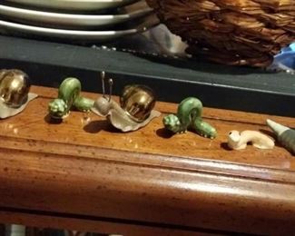 collection of ceramic critters that inch along - slugs, inchworms, etc