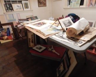 Table full of loose art work.