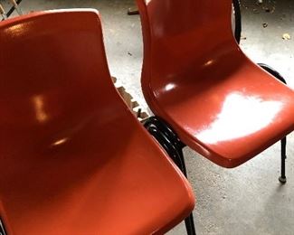 Mid century orange bucket chairs. 