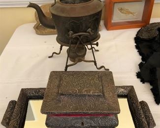 Tunisian embossed silver items in front of an old copper pot