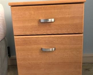 One of two small filing cabinets doubling as bedside tables