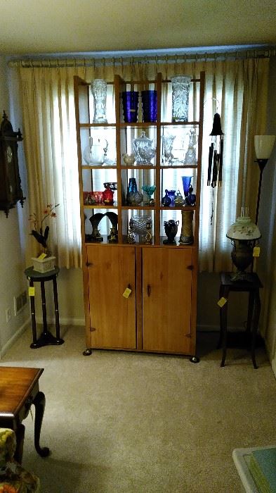 Great display cabinet with lead crystal vases, pitchers, Roseville and Weller pottery, brass, cobalt glass and Bohemian cut to clear glass, Bradley Hubbard Lamp