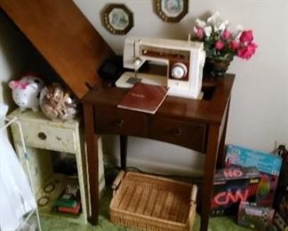 Singer sewing machine cabinet, pottery piggy bank, rose bowl full of sea shells