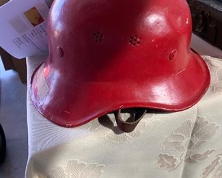 German helmet from WWII that has been painted red for fire duty