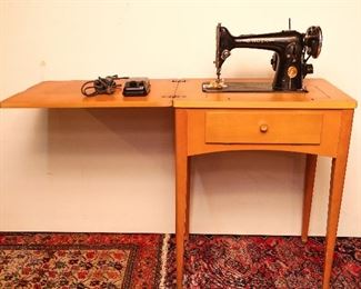 2nd Antique Singer Sewing Machine with Attached Lamp Light and Cabinet at This Sale.