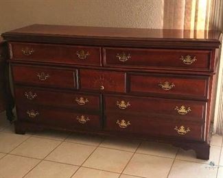 Dark Wood Dresser	
Seven Drawers with Gold-Colored Knobs and Handles; 65"w x 18"d x 35"h
