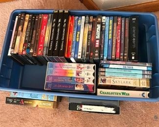 Assorted Lot of DVDs and VHS Tapes in Tub