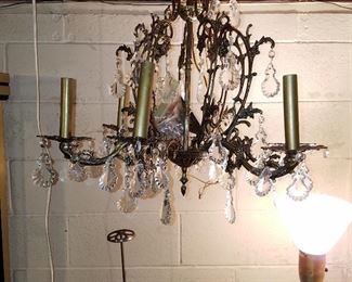 Chandelier with prisms (additional prisms in plastic bag in center. Metal 'thingy' below chandelier to left is a store display for hats