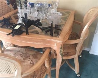 Lovely glass top game table with wood supports and four matching chairs