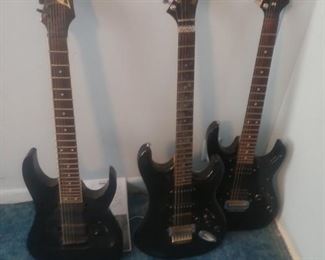 3 electric guitars two are Ibanez