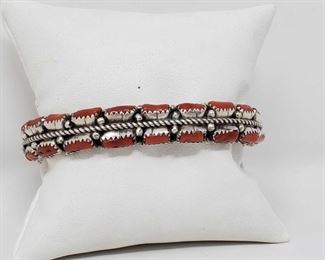1101:
Native American Handmade Sterling Silver Coral Cuff Bracelet
This beautiful Native American Handmade Sterling Silver Coral Cuffed Bracelet weighs approximately 52.0g and measures approximately 2.5in.