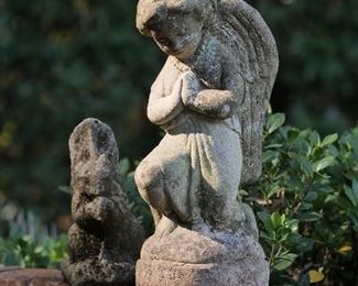 Charming cast stone praying angel and friendly squirrel