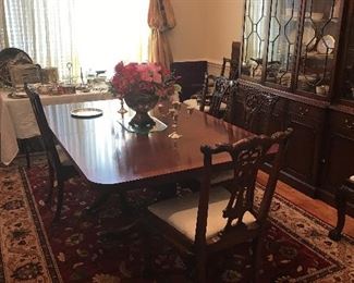 Very beautiful double pedestal table with inlay. I took 2 leaves out. Custom table pads. 8 High quality reproduction Chippendale chairs. 3-section, lighted china cabinet, cherry tea cart. Also has a match8ng Buffett currently being used as an entrance piece.