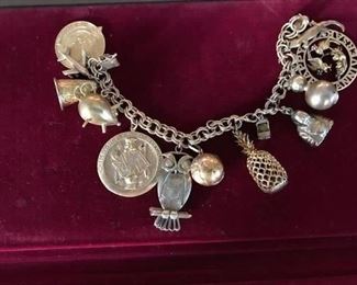 Very heavy charm bracelet, 14k charms with two 18k charms. Looks a little silver but ALL gold
