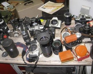 assorted cameras, lenses, tripods and equipment