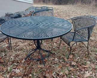 wrought iron patio table, assorted chairs