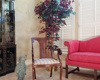 Mahogany armchair and faux ficus tree with statue