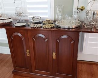 Mahogany flip top server with silverplate and glass serving pieces