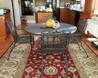 Machine made Oriental style rug and Woodard patio table and four chairs