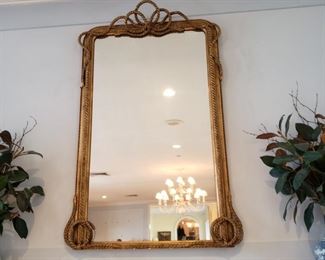 Just added! Gilt wall mirror decorated in a braided rope motif, it's above the mantle and I'm sorry I didn't get measurements
