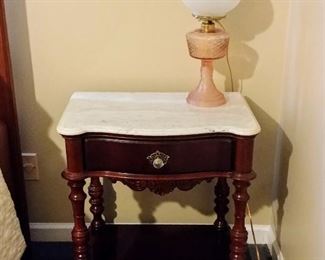 Victorian style mahogany night stand with a marble top