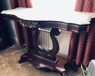 Victorian era mahogany harp table with marble top (there are two matching tables)
