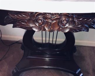 Close up of the carved decoration on table front