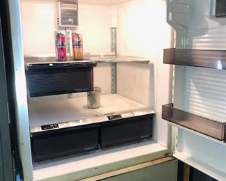 Older GE refrigerator/freezer on the bottom located in the basement. Works well.