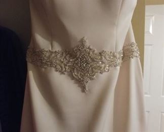 Size 12 strapless wedding dress with intricate bead work at the bodice and on the back.